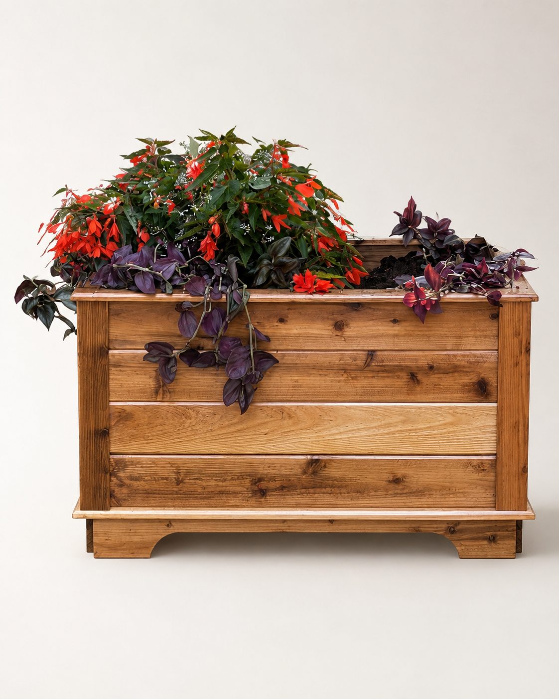 Slatted cedar planter box raised on a plinth, planted with red and purple flowers